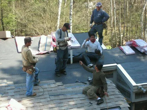MasterCraft roofers working on a new shingle roof in Braintree, MA